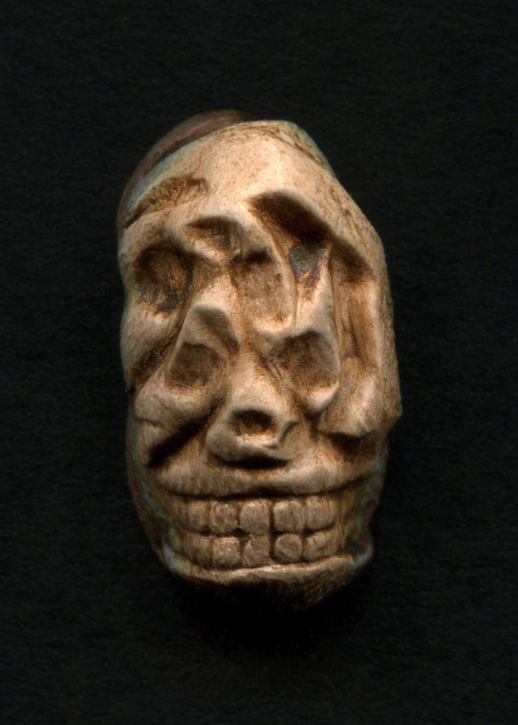 a large carved stone head on a dark background