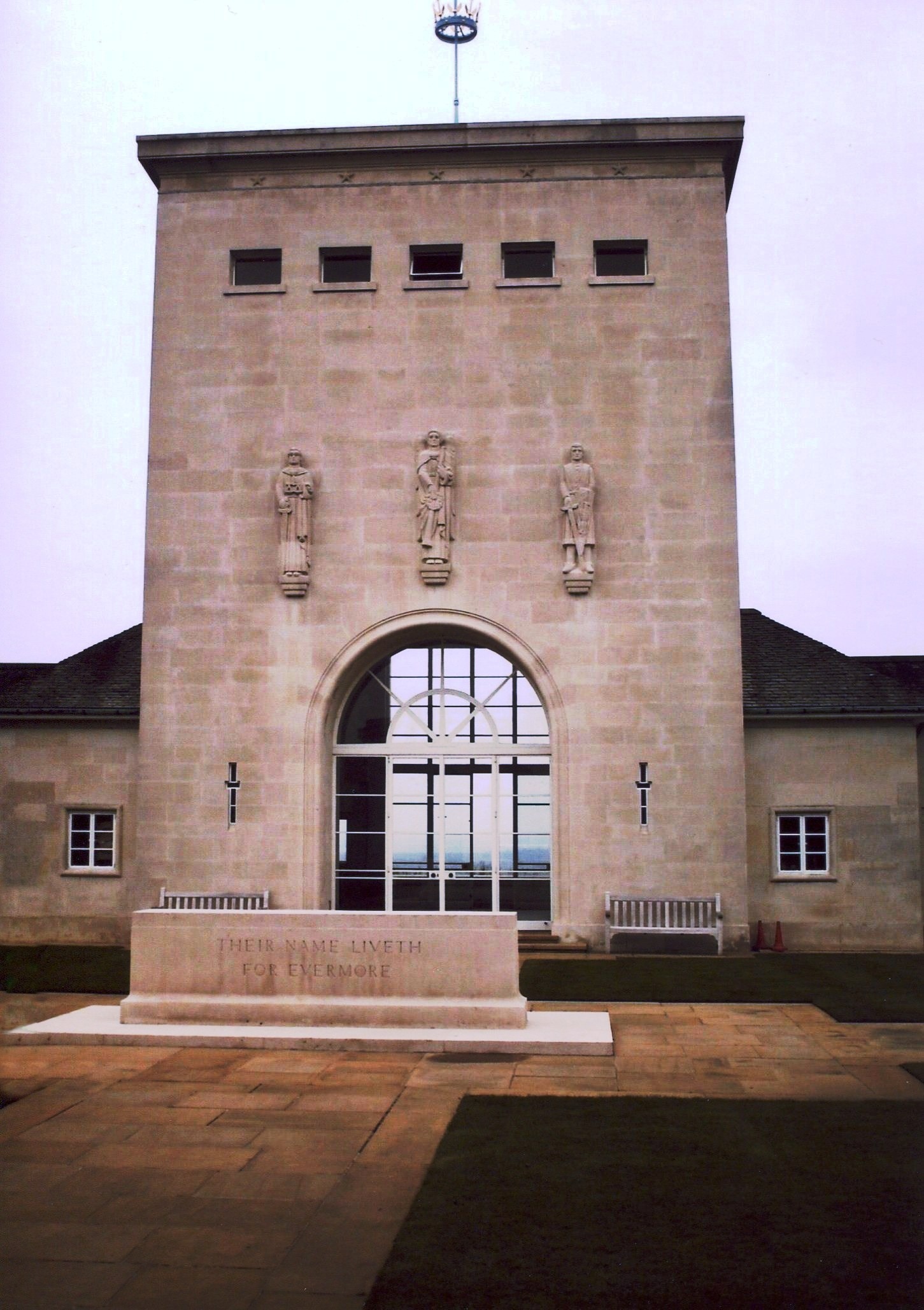 an elegant white monument stands in front of a building