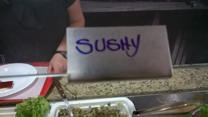 the sign says sushi in blue letters