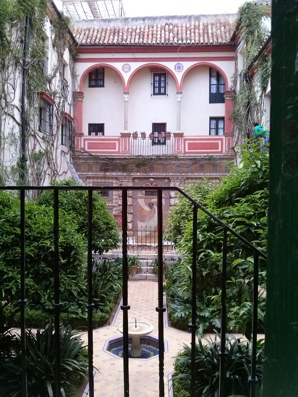 a courtyard with a fountain surrounded by trees