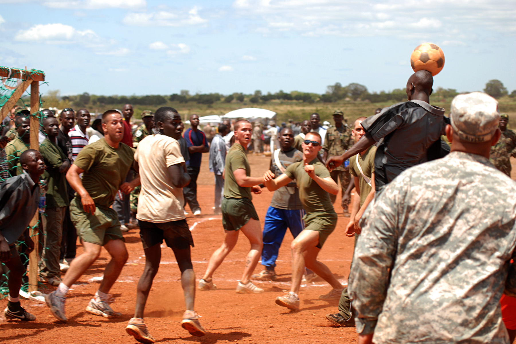 a group of men playing baseball in the dirt