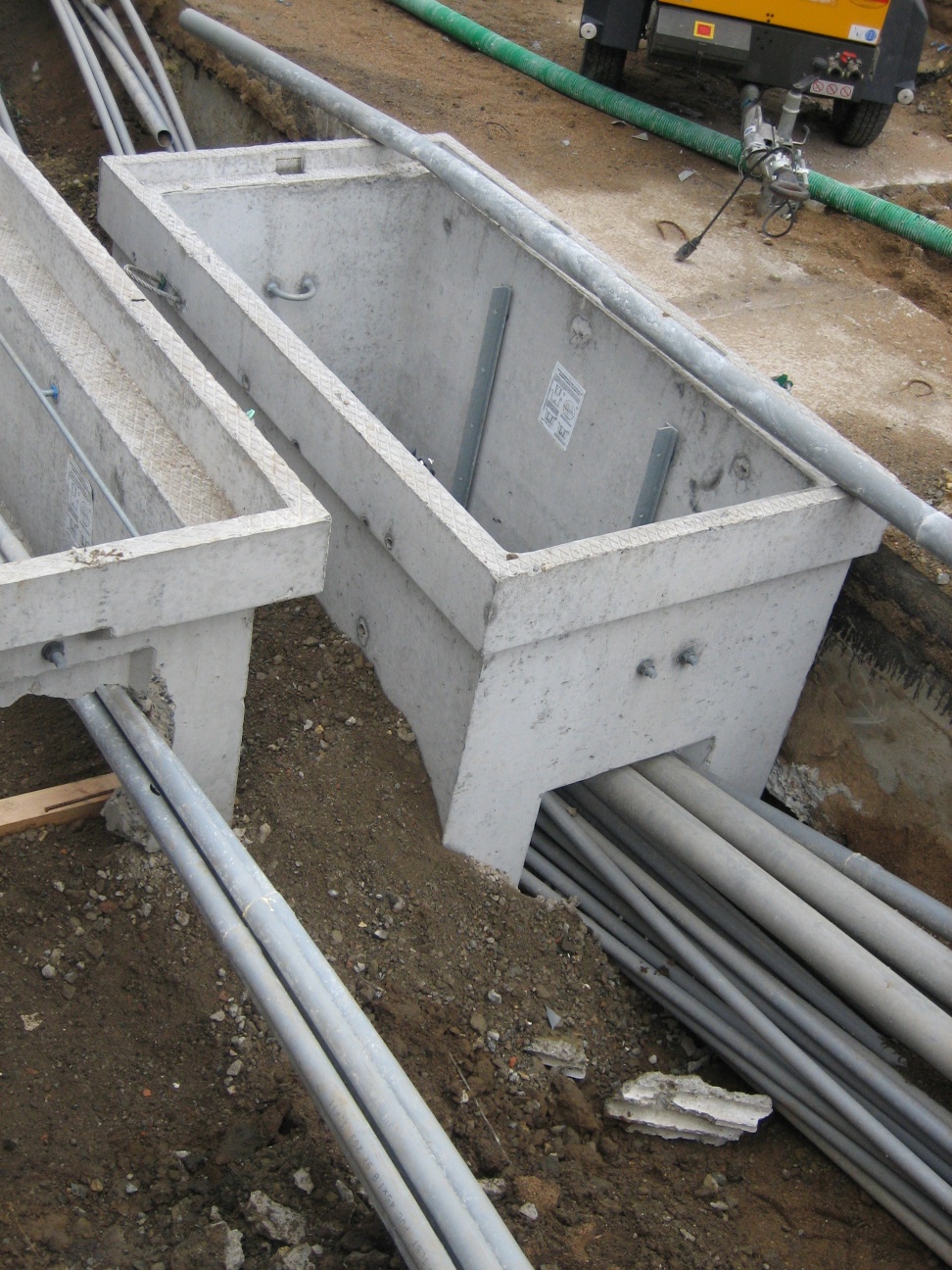 pipes and plumbing laying on ground in construction area