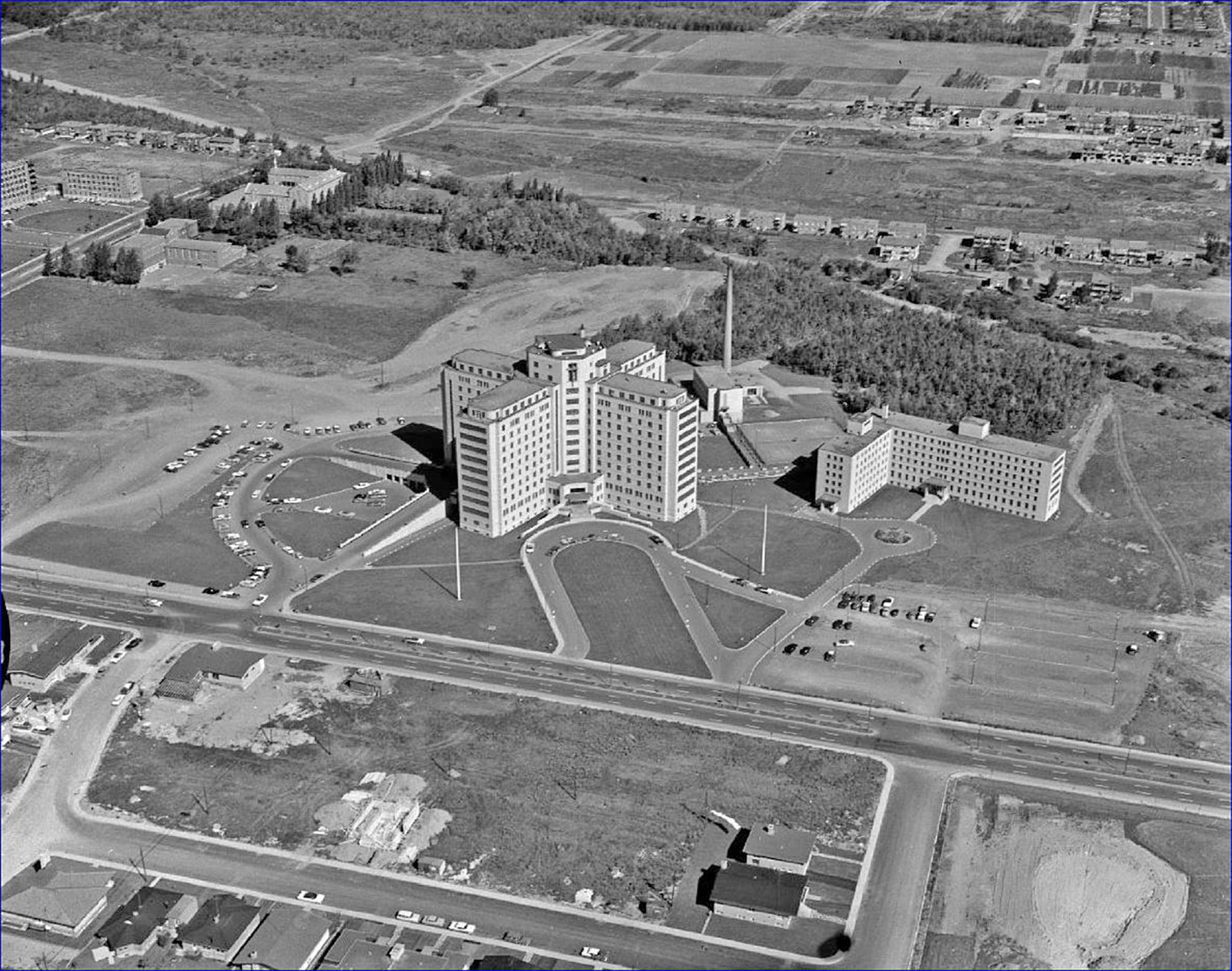 an old image of a large building on top of a hill