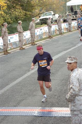 a man in an army uniform running down a street