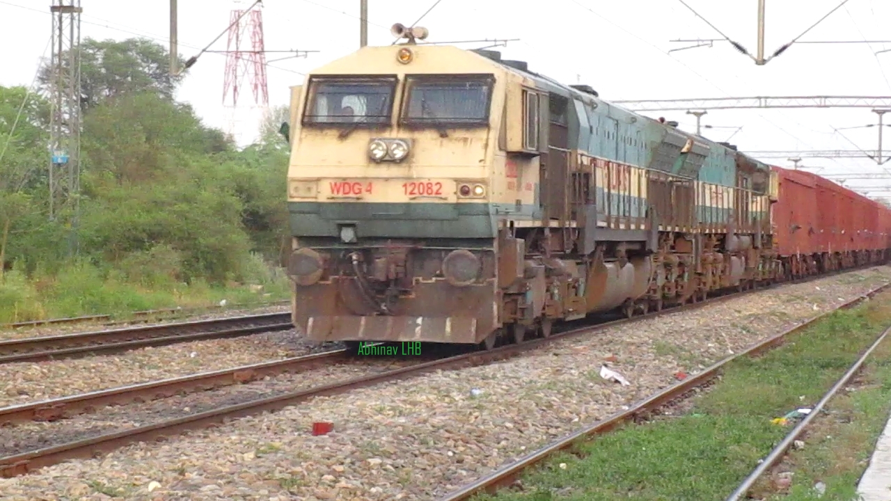 an old yellow train that is sitting on train tracks