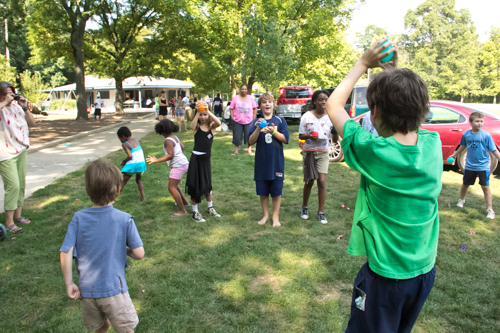 a man plays frisbee while a group of people watch