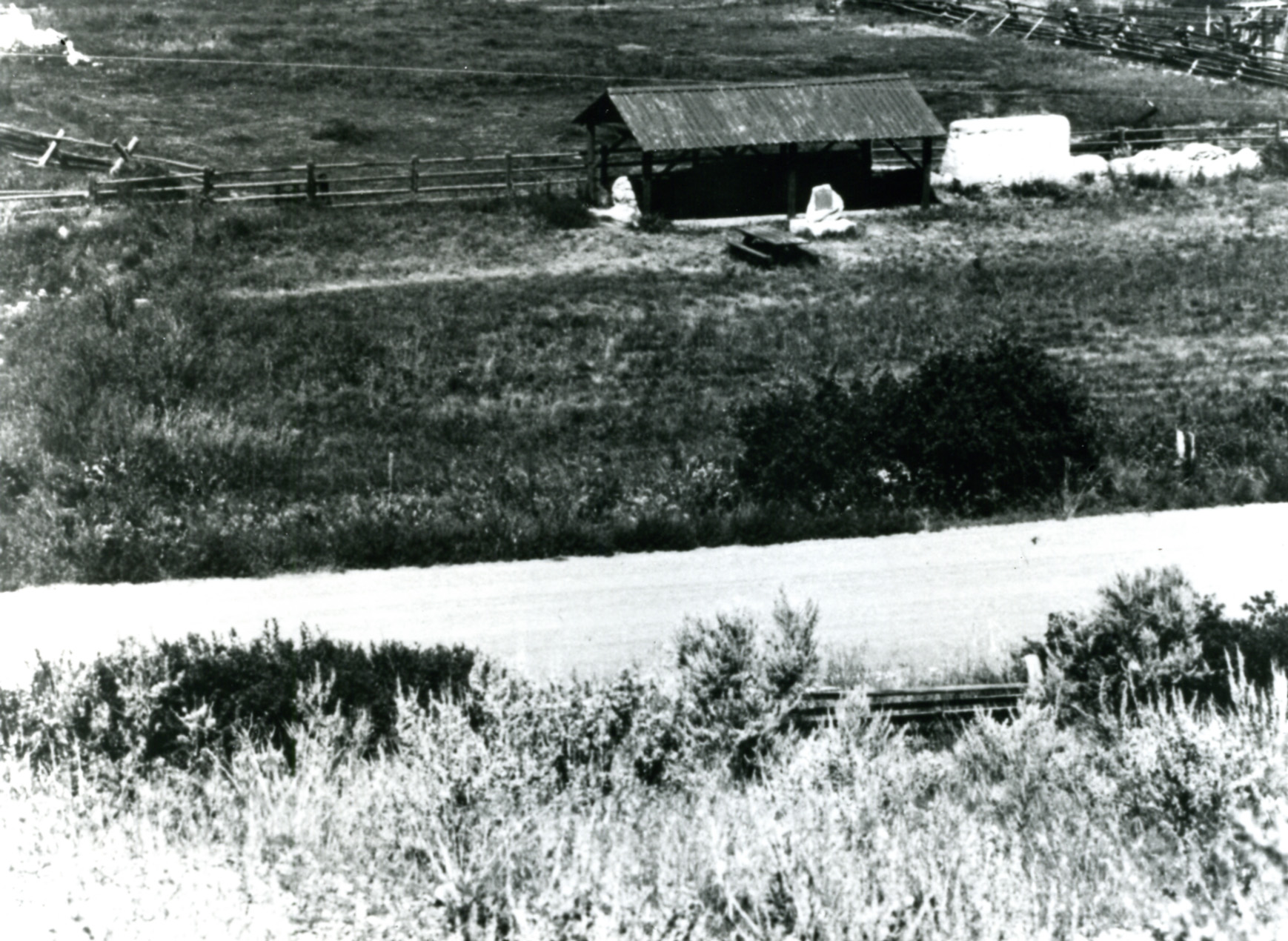this black and white po shows an old farm building