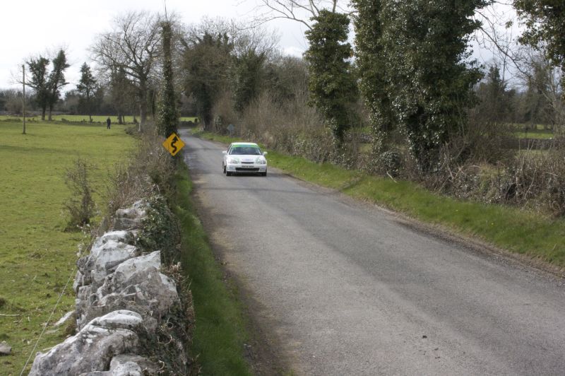 a white car sitting on the side of a road