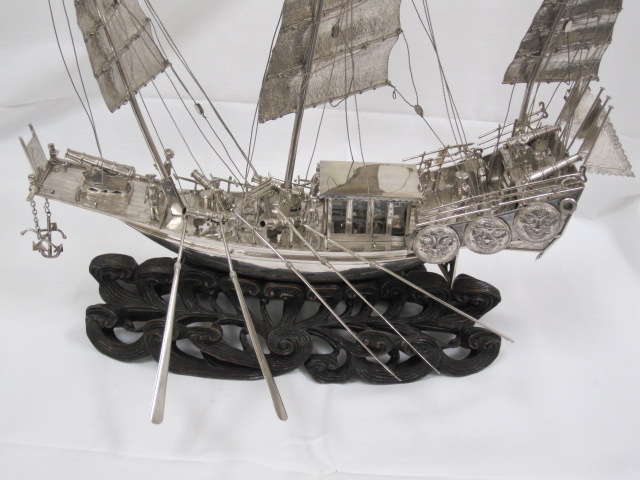 the model ship is made out of metal and metal strips