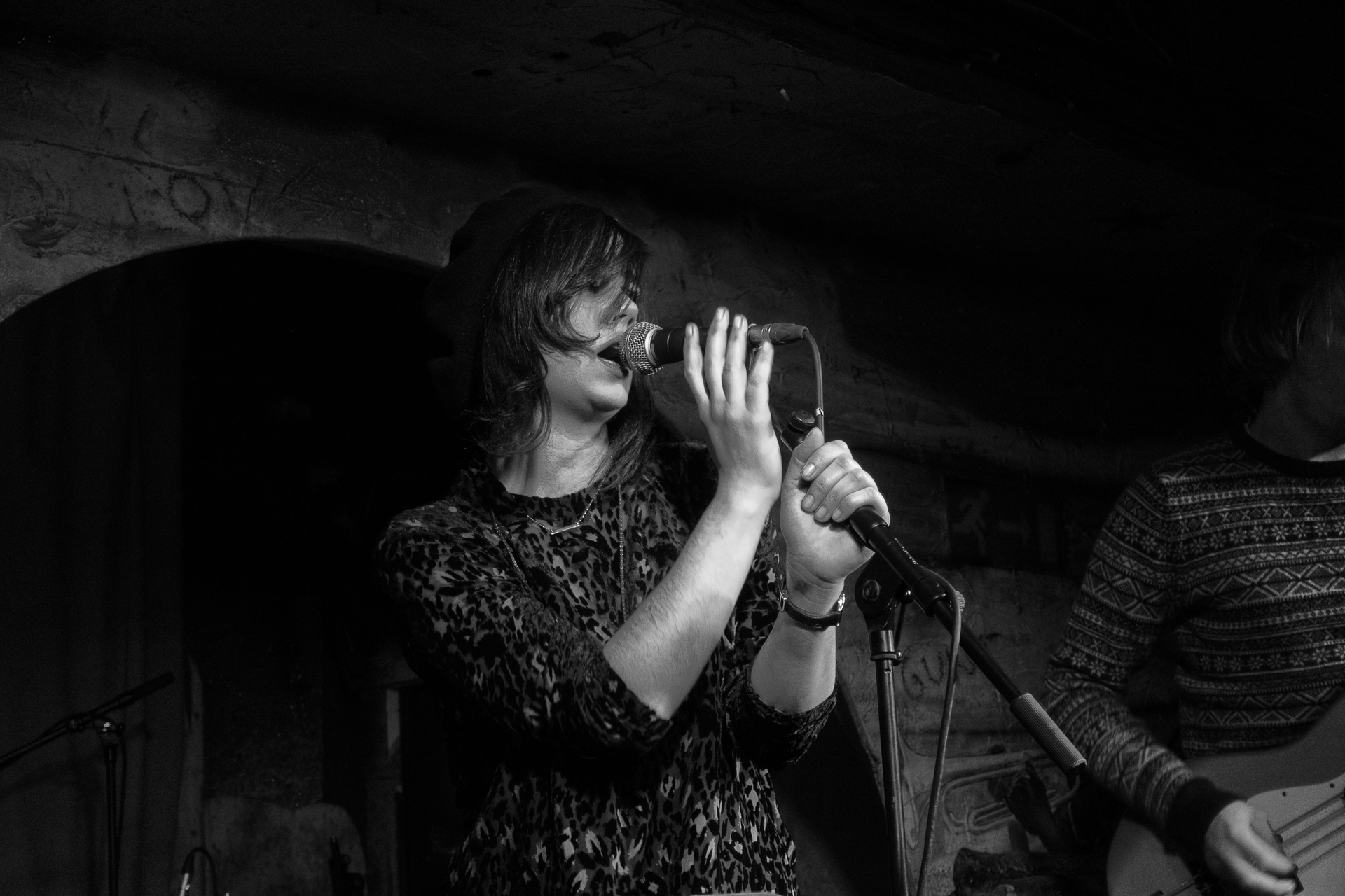 a woman holding a microphone up to her mouth