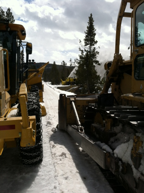 a snow plow parked on the side of a road