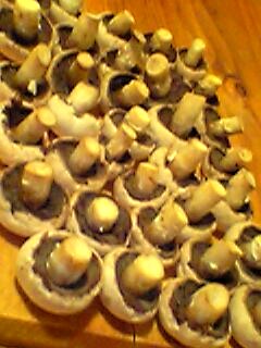a number of slices of mushrooms on a wooden table