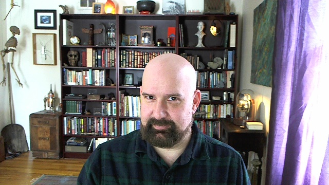 an image of a bald man that is in the living room
