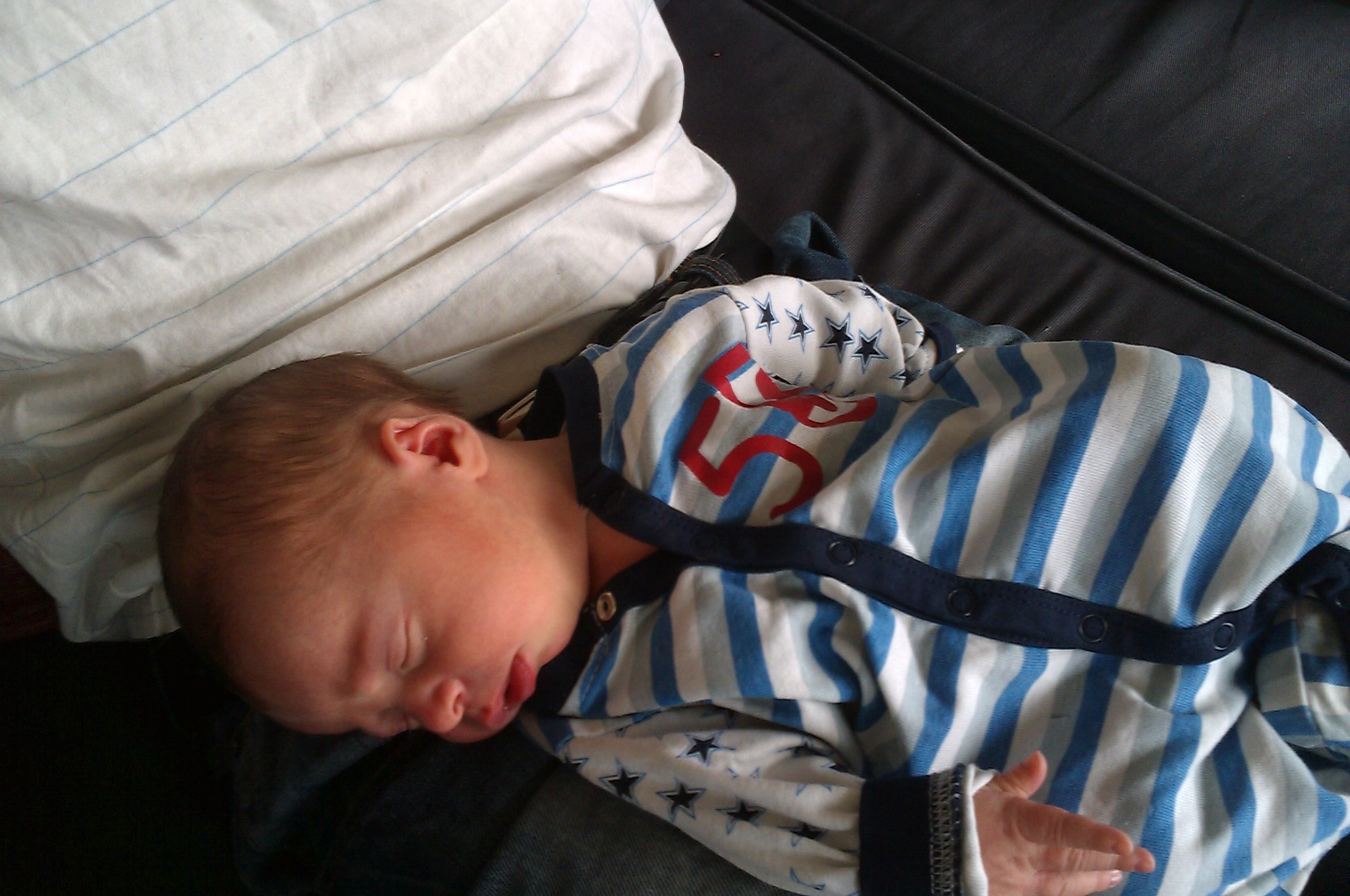 a small child with his mouth on the bag