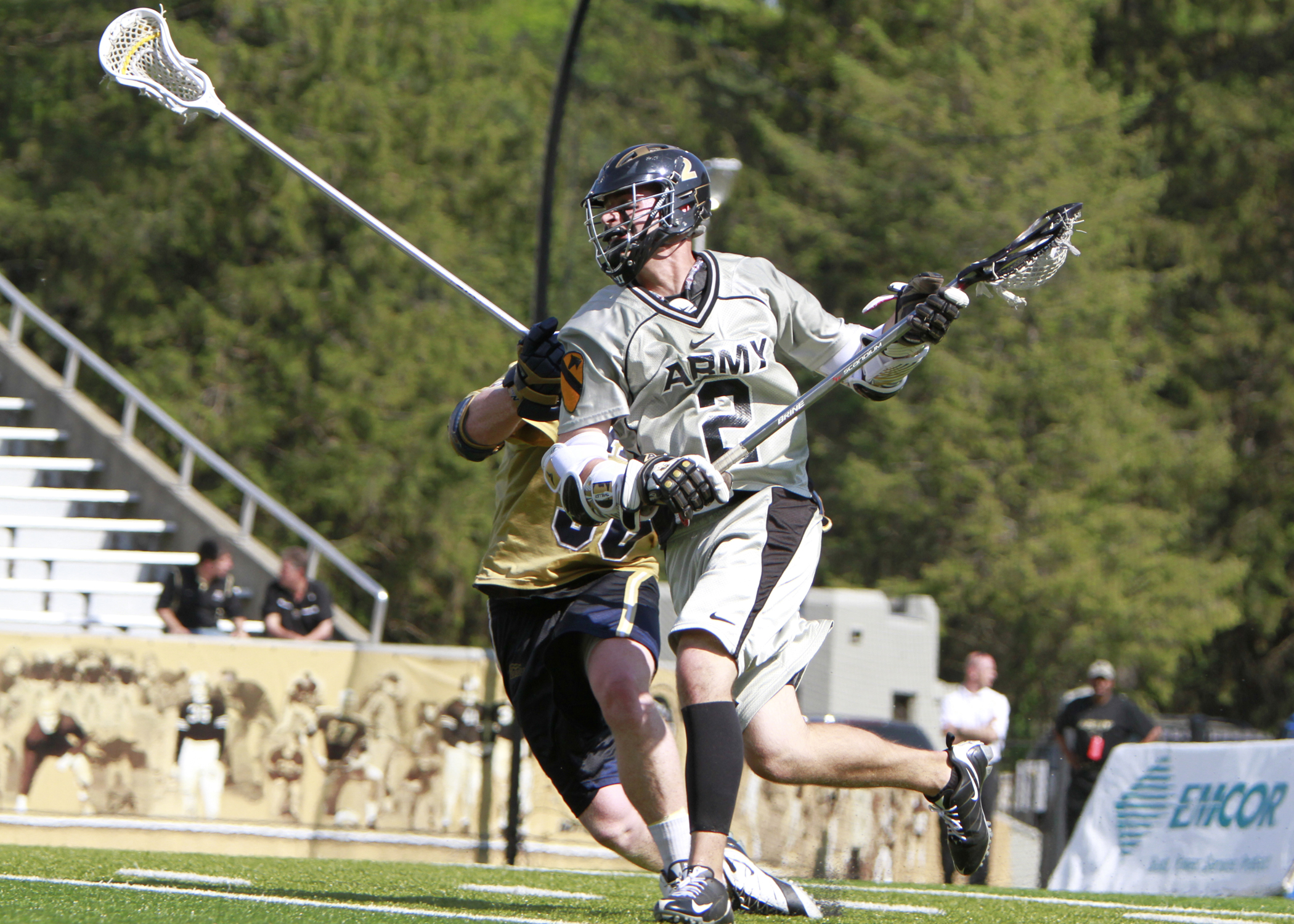 two lacrosse players running with each other