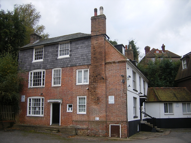 an old brick building with a tall chimney