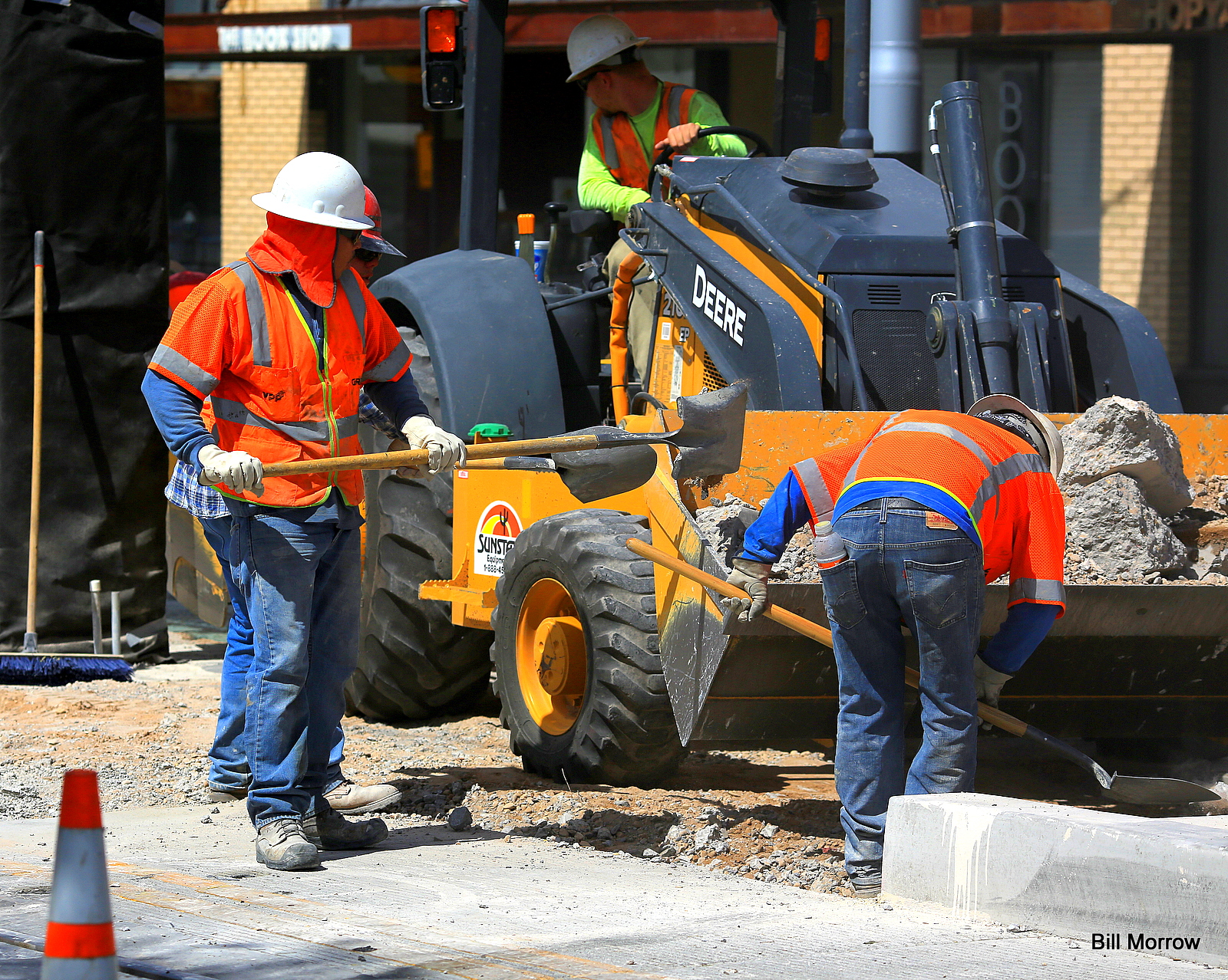 construction workers with shovels working on a construction site