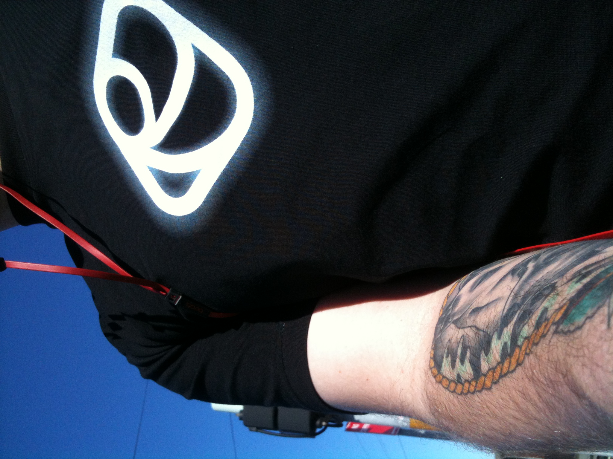 a tattooed arm with a clock on it and the logo of the swiss army on the arm