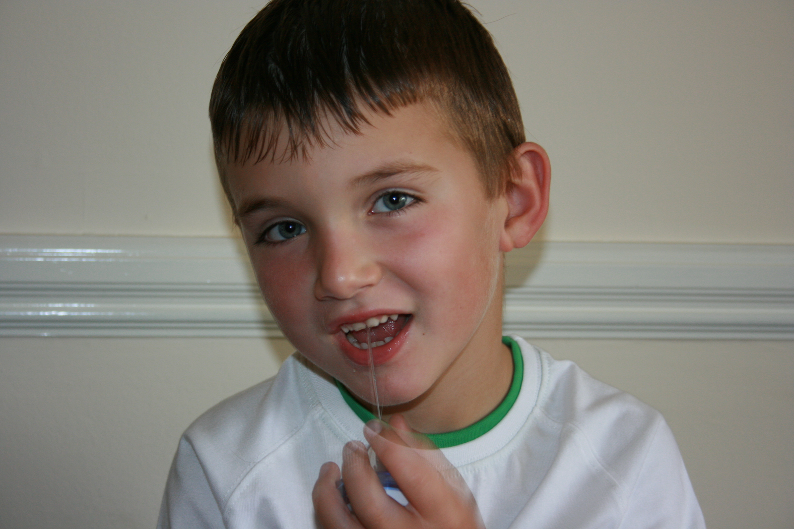 a boy with toothbrush in his mouth is standing