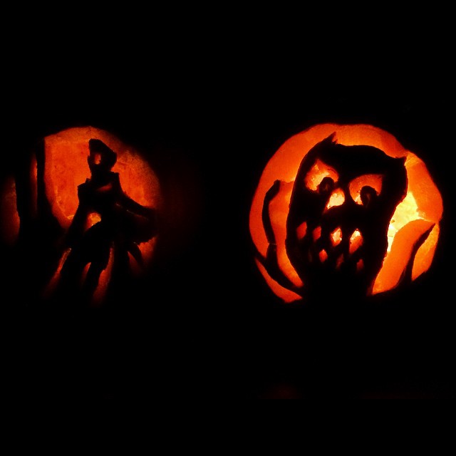 a couple of carved pumpkins sitting on top of a table