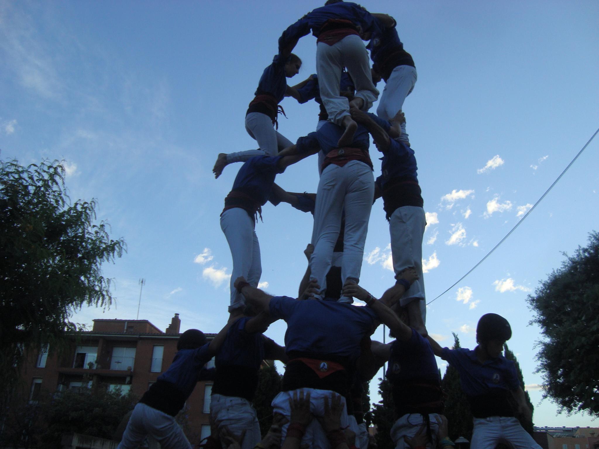 a group of people huddle around a statue