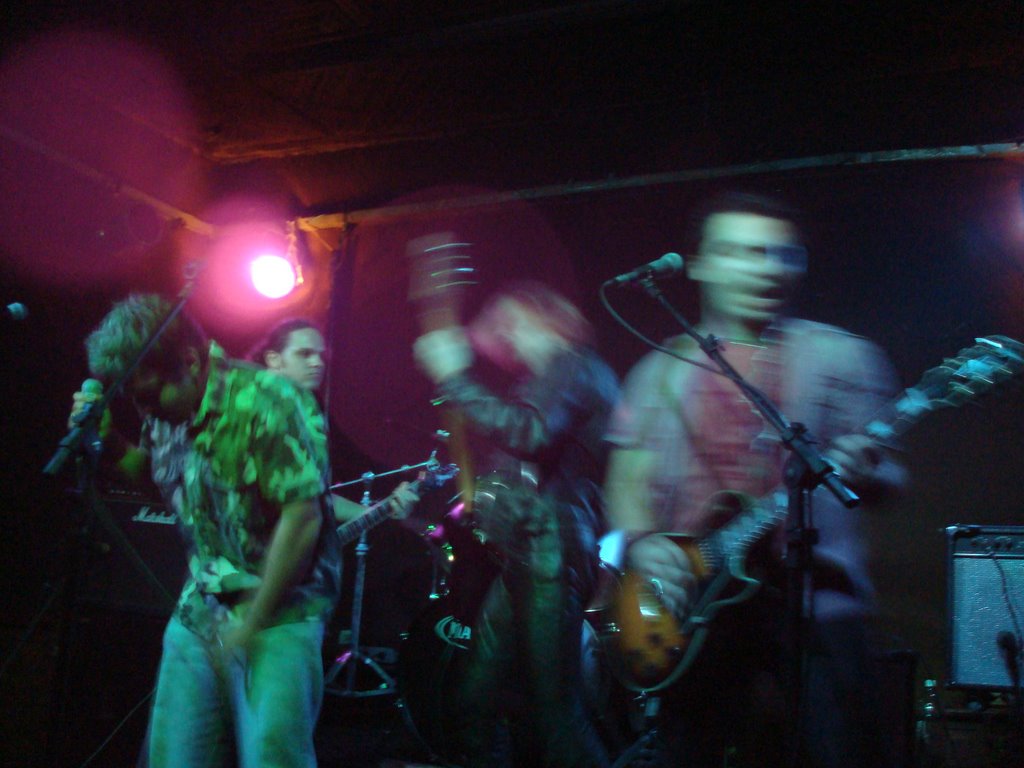 two men in shirt and jeans standing on stage