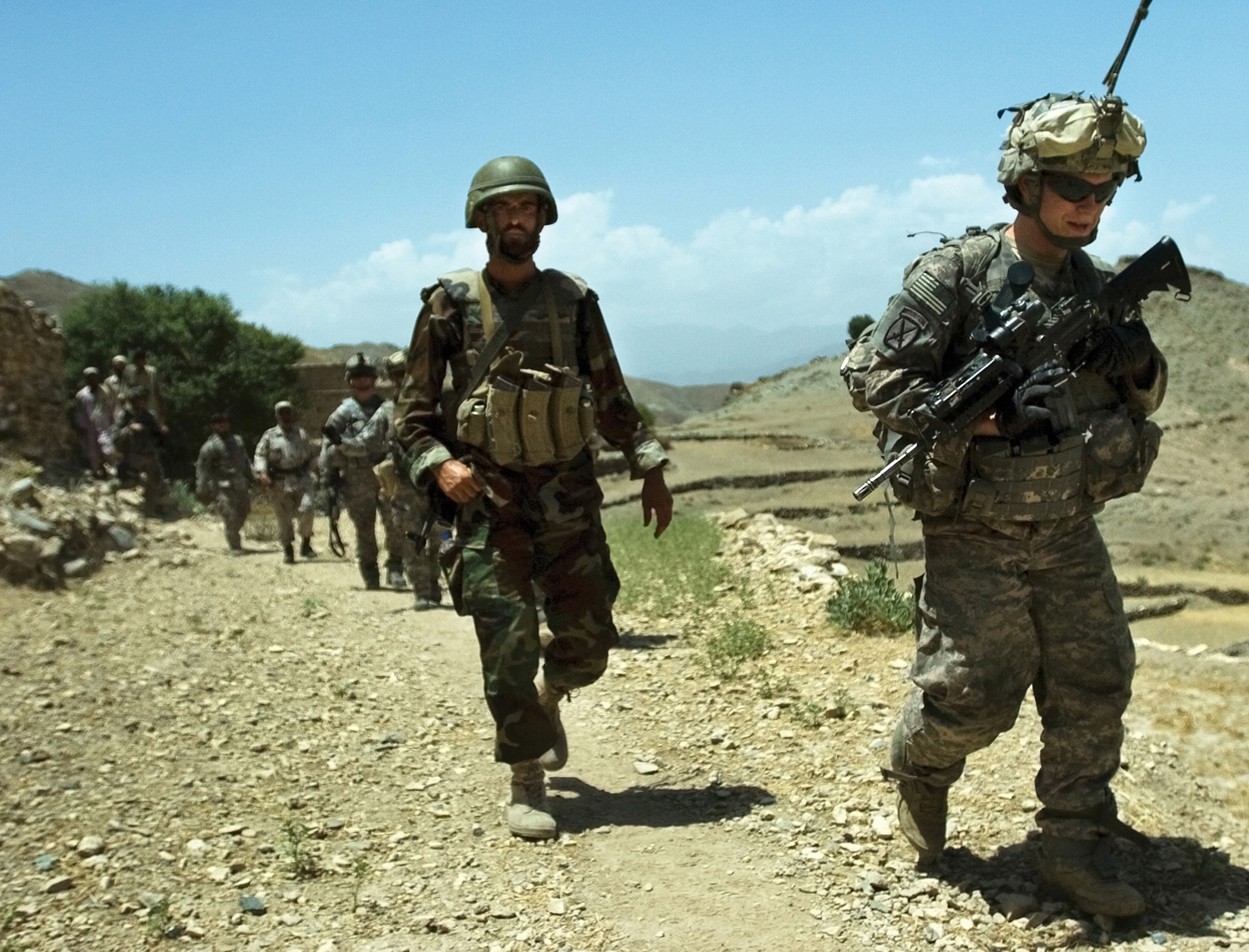 a group of military men walking on the street