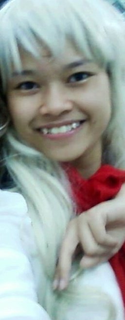 the woman is smiling with blonde hair and wearing a red shawl