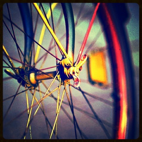 the spokes on a yellow and red bicycle wheel