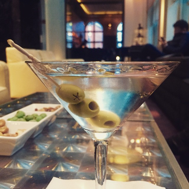a small martini glass with olives in it