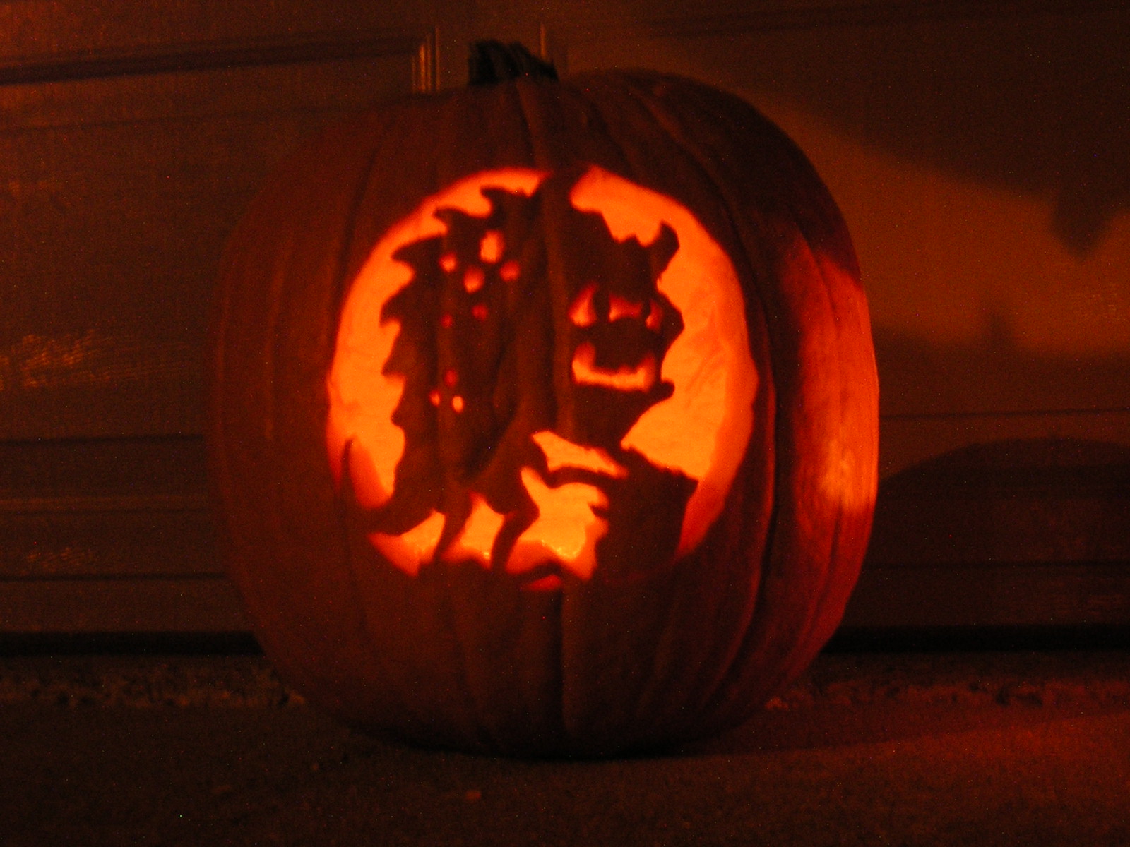 carved pumpkin with a monogrammed image on it