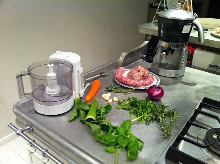 several vegetables on the counter next to a meat grinder