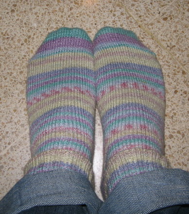 feet up to a persons legs wearing colorful socks