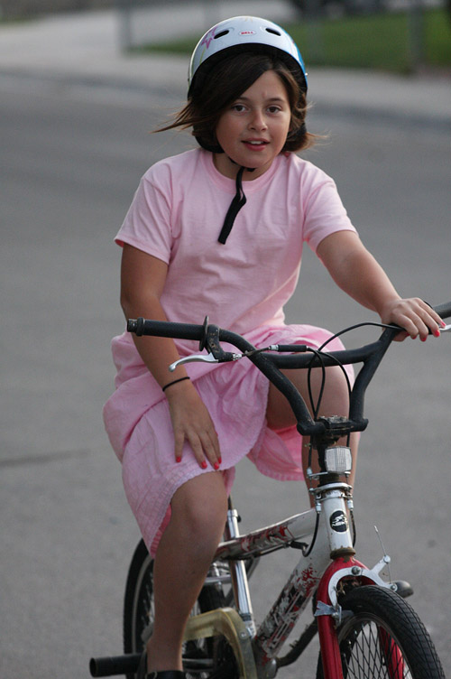 a  smiles while riding her bike