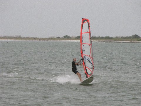 a wind surfer on a still body of water