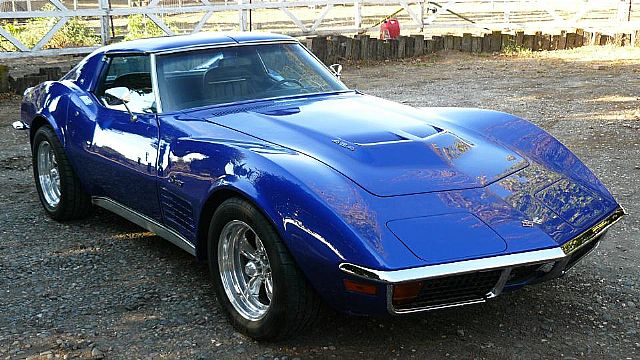 a blue sports car is parked in a parking lot