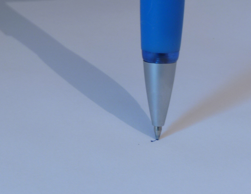 the blue pen is laying across a white background