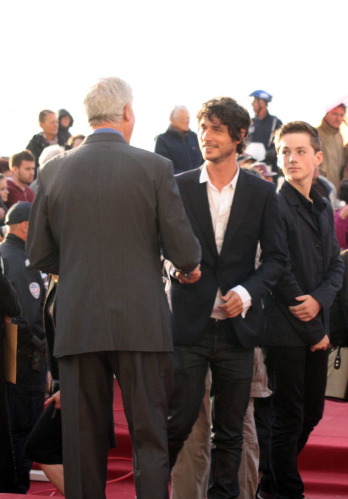 two men are shaking hands at a ceremony