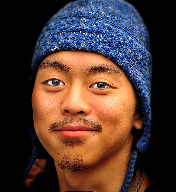 a man with a knitted blue hat looking directly at the camera