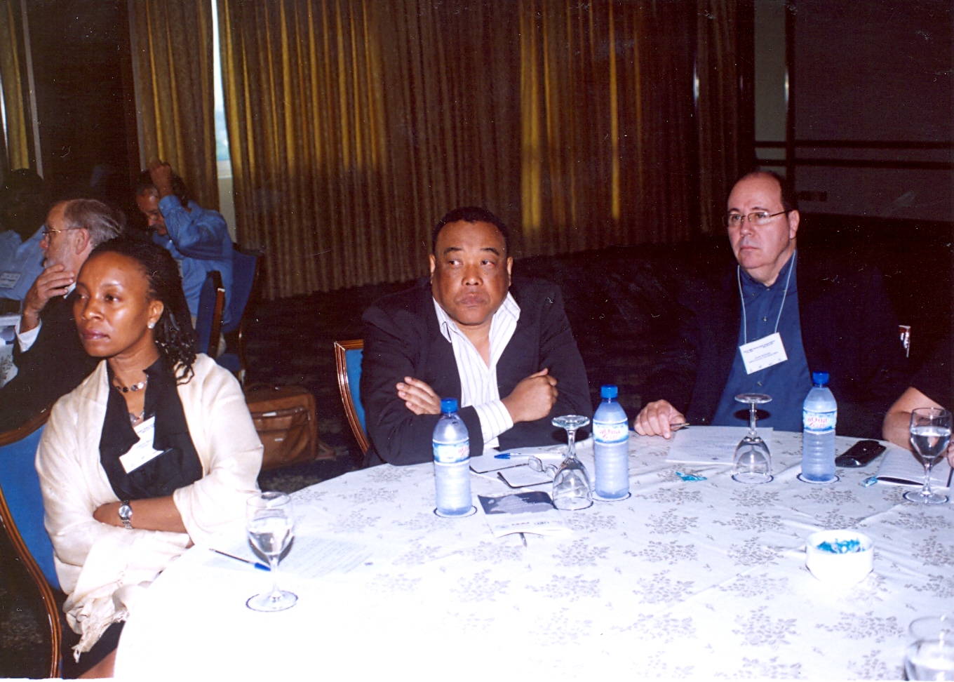 several men and women sitting at a table having a discussion