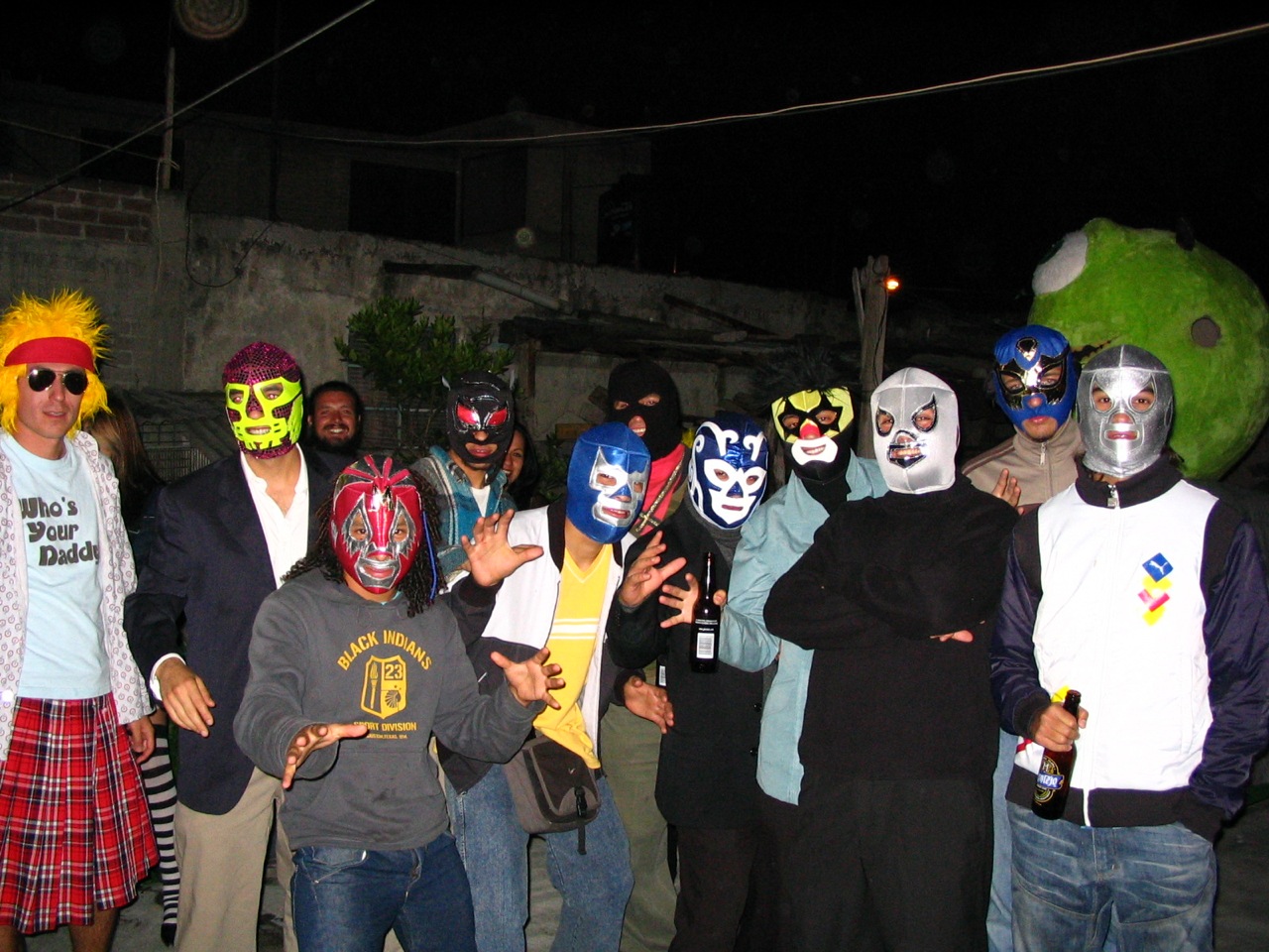 some people wearing masks stand together near one another