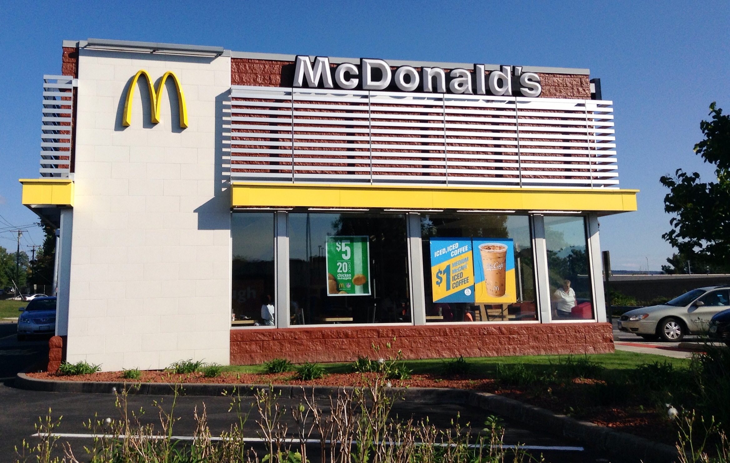 this mcdonald's is located on the corner of a parking lot