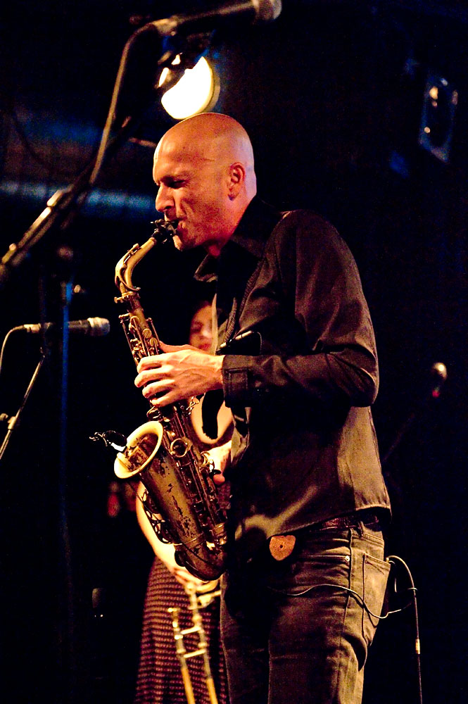 a man standing with a saxophone in his hand