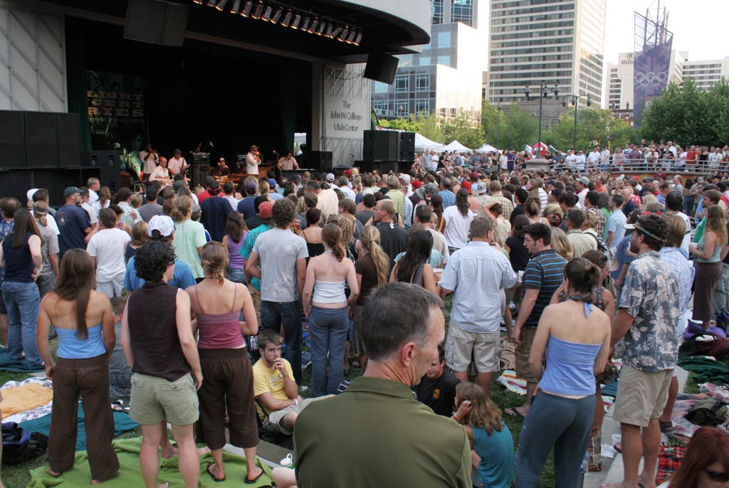 a large crowd of people gather in a city