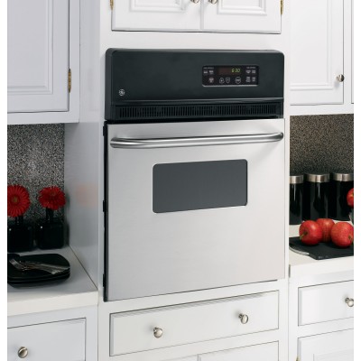 an electric range in a kitchen with white cabinets