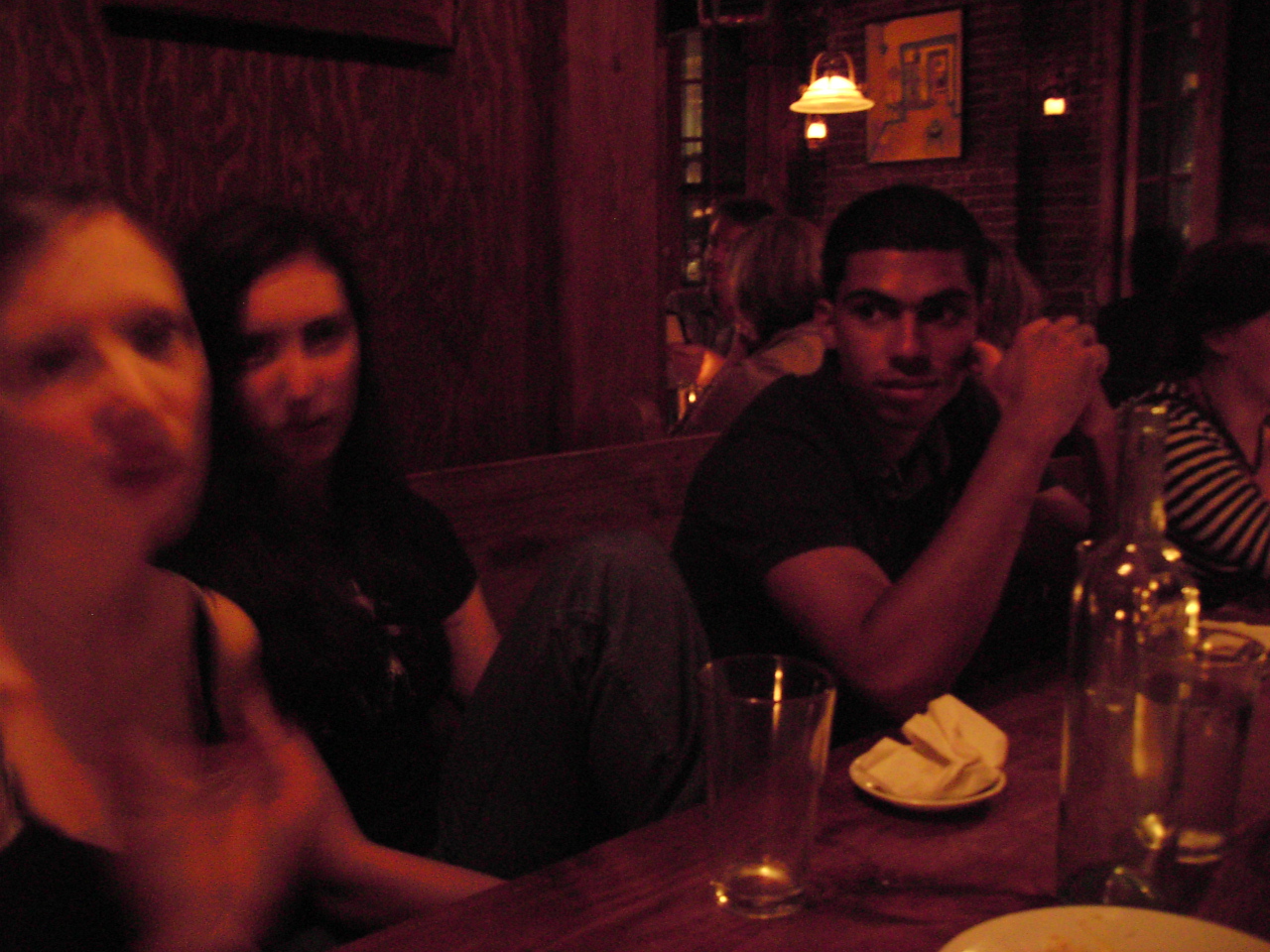 several people sitting at a table in a restaurant