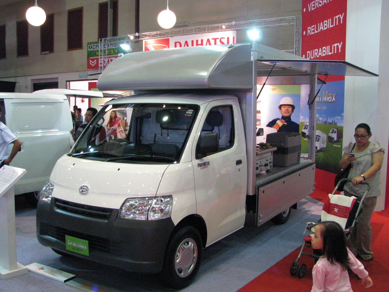 an ice cream truck and a woman speaking to a man