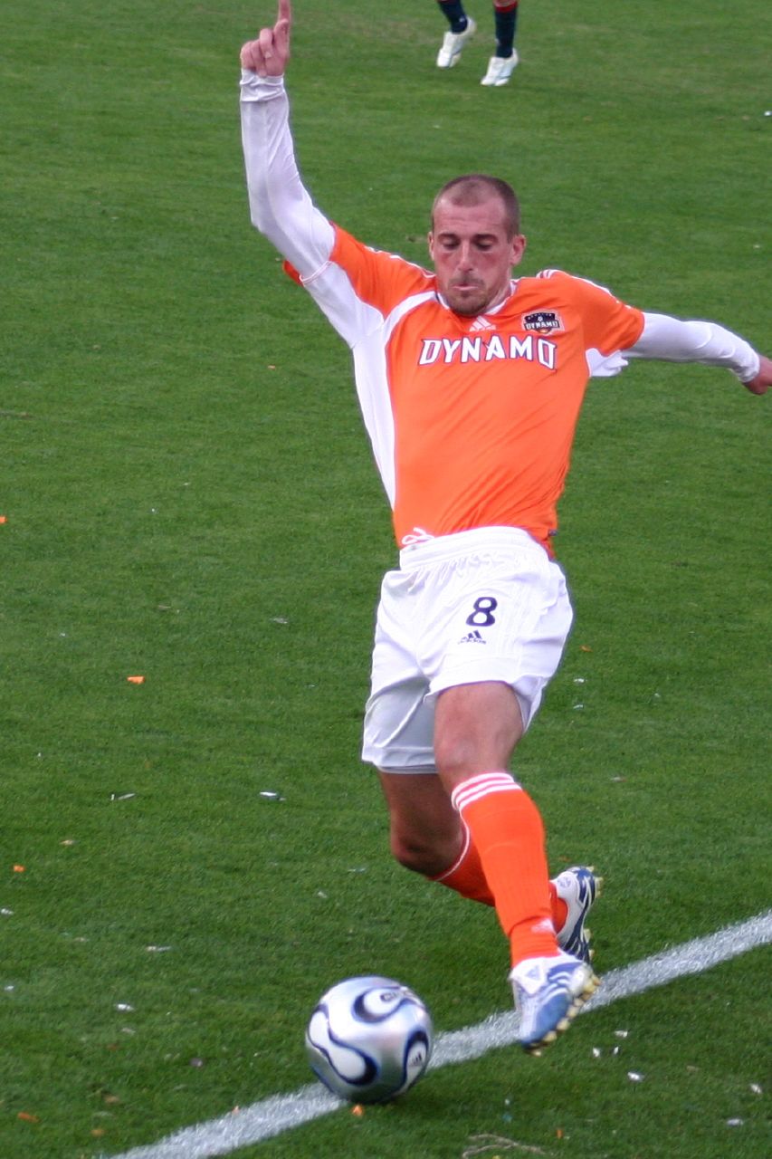 a soccer player dribbling a ball in the field