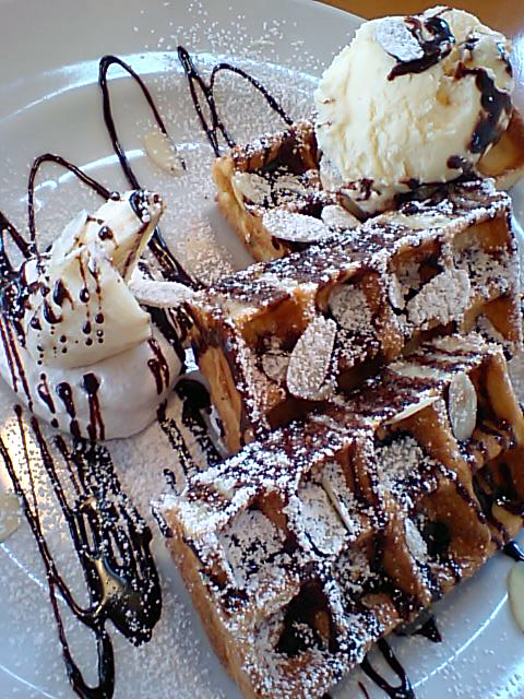 waffles, bananas and chocolate on white plate