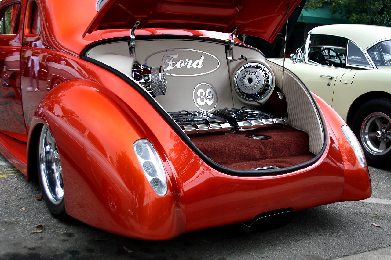 an old time car with an open trunk